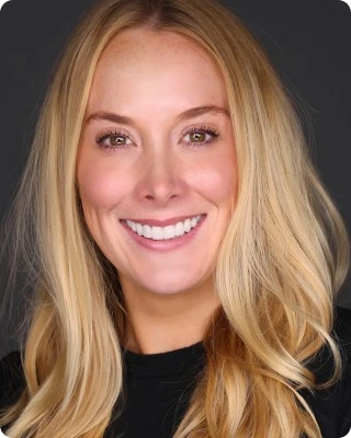 Professional headshot of Alli Manning, Chief Operating Officer at Challenger Inc, smiling confidently in business attire